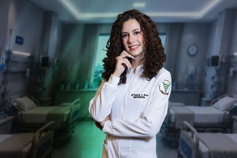 Formanda de jaleco posando no cenário temático de hospital